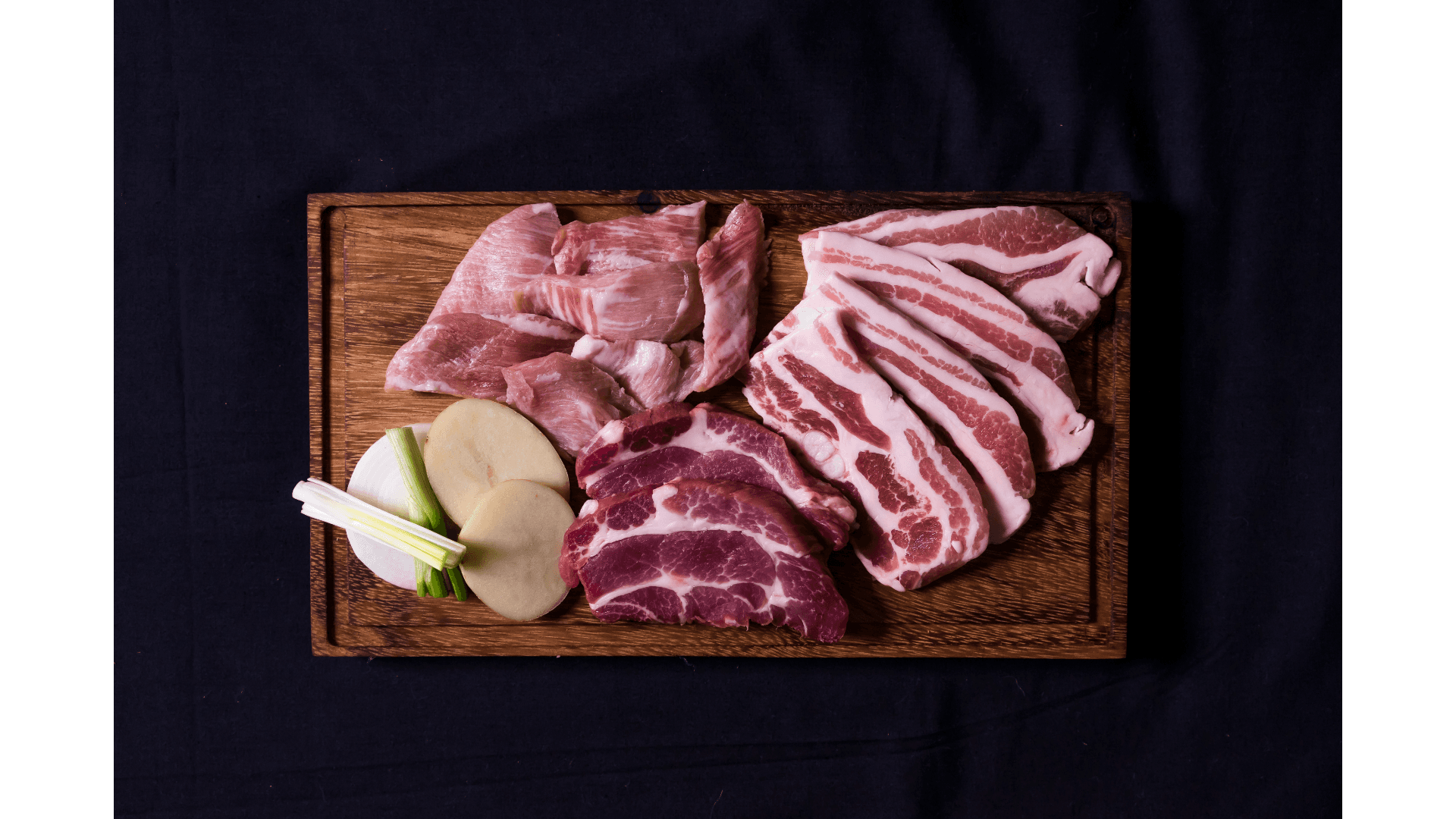 Cuts of meat on a butcher board
